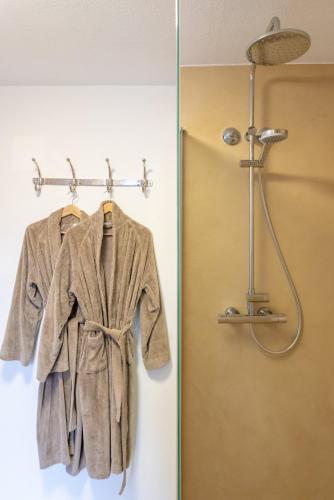 a robe hanging on a rack in a bathroom at Princess No3 Self Check-In Plochingen bei Stuttgart in Plochingen