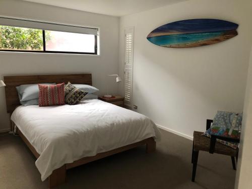 a bedroom with a bed and a painting on the wall at Pacific Paradise in Torquay