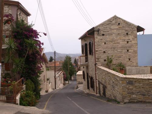 an empty street in a village with buildings at Iosiphis Stonebuilt House in Pano Lefkara