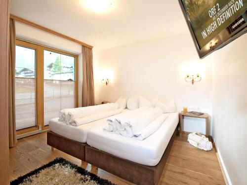 a white couch in a room with a window at Landhaus Anja in Neustift im Stubaital