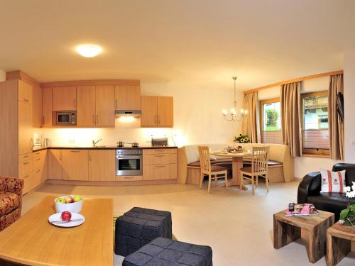 a kitchen and living room with a table and chairs at Landhaus Anja in Neustift im Stubaital