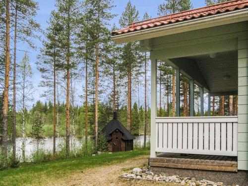 a house with a small house next to a lake at Holiday Home Yläneuvola lanssi by Interhome in Neuvola