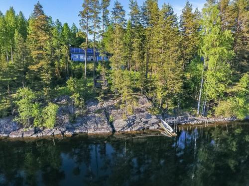 a house on the shore of a body of water at Holiday Home Norppa by Interhome in Vuoriniemi