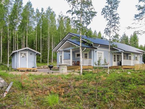 a tiny house in the woods with a porch at Holiday Home Nestori by Interhome in Vuoriniemi