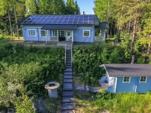 an aerial view of a blue house with solar panels on it at Holiday Home Norppa by Interhome in Vuoriniemi
