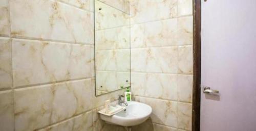 a bathroom with a sink and a mirror at Hotel Simran Pride, Raipur in Raipur