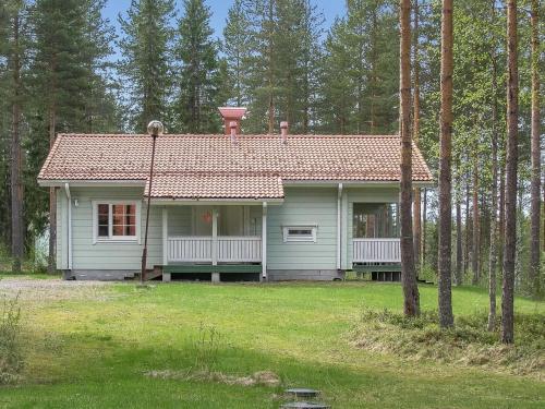 a small white house with a red roof at Holiday Home Yläneuvola niemi by Interhome in Neuvola