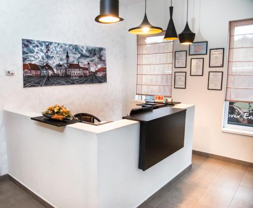 a kitchen with a white counter top in a room at Pensiunea Carmen - Bikers Friendly Nest in Sibiu