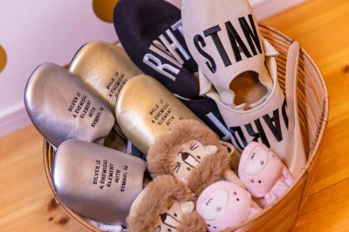 a basket filled with pairs of shoes and stuffed animals at Inari Ohan in Kyoto