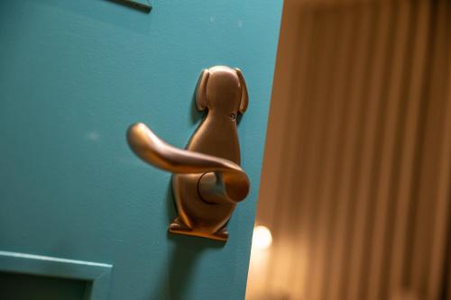 a wooden door knob on a blue door at Inari Ohan in Kyoto
