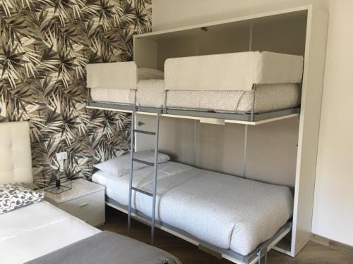 two bunk beds in a room with a wall at Appia Garden in Rome