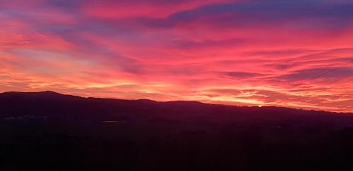 a sunset with a purple and red sky at Landhotel SONNENHOF MotorradKrauk in Ulrichsberg