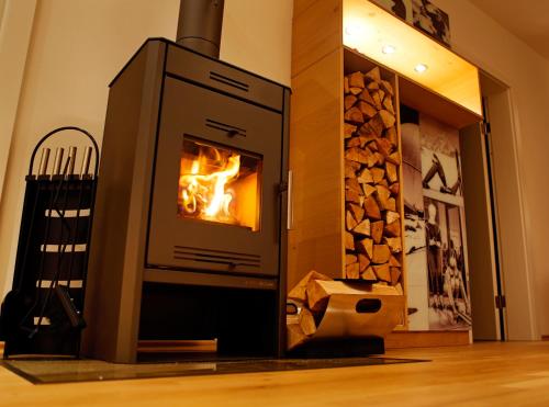 a oven with a fire in it in a room at Sportappartements in Bad Mitterndorf