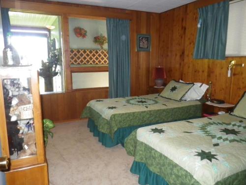 a hotel room with two beds and a window at Beach Estates Inn Bed and Breakfast in Nanaimo