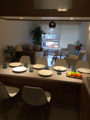 a room with a table and chairs and a living room at Condominio Parquemar!!! in El Tabo