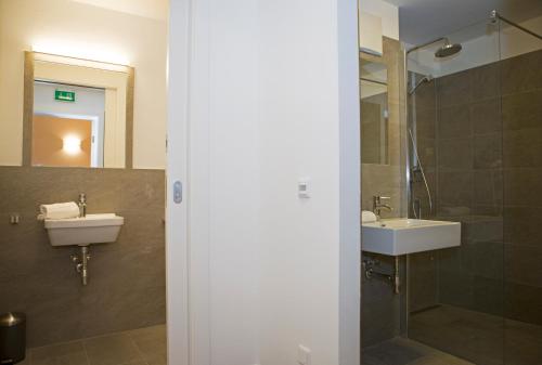 a bathroom with two sinks and a shower at Sportappartements in Bad Mitterndorf