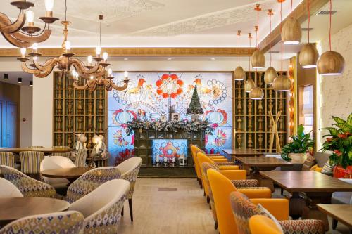 a restaurant with a fireplace and tables and chairs at Родичі in Zhashkiv