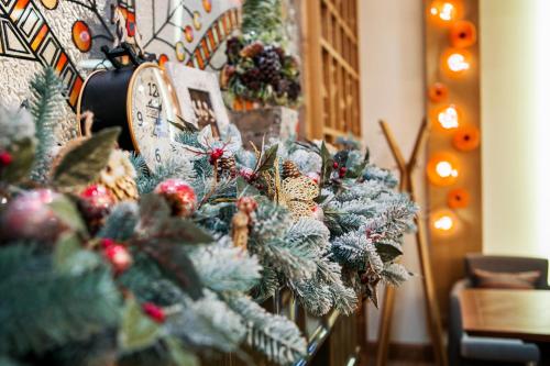 a christmas tree and a clock on a wall at Родичі in Zhashkiv