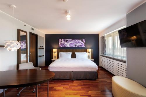 a hotel room with a bed and a table at Radisson Blu Hotel Lietuva in Vilnius