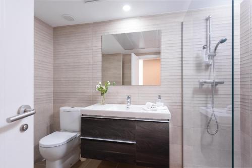 a bathroom with a toilet and a sink and a shower at Playa & Golf in Alicante