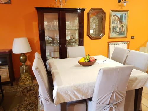 a dining room with a table with a bowl of fruit on it at B&B Vista su Roma in Marco Simone