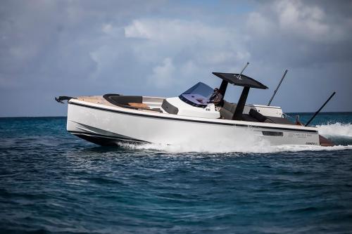 a man in a white boat on the water at Carlisle Bay in Old Road