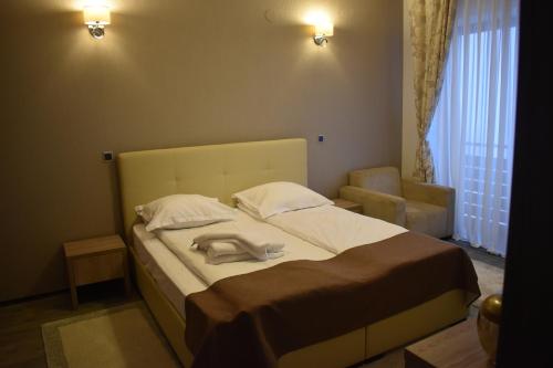 a bedroom with a large bed with two pillows at Silver Mountain G1 43 in Poiana Brasov