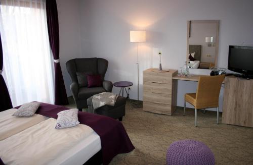 Ένα ή περισσότερα κρεβάτια σε δωμάτιο στο DAS HUDEWALD Hotel & Resort