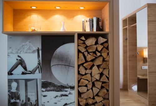 a room with a book shelf filled with logs at Sportappartements in Bad Mitterndorf
