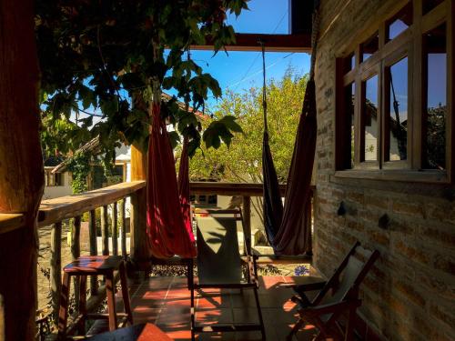 a patio with chairs and hammocks on a porch at Hostal Mamá Hilda in Chugchilán