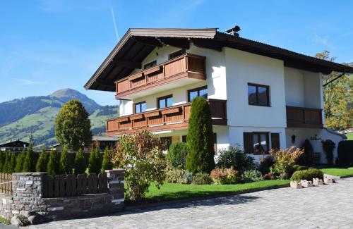 a house with a fence in front of it at Apartment Brandstätter 1 & 2 by Apartment Managers in Brixen im Thale