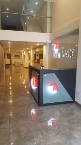 a lobby with a hotel may sign in a building at Hotel Max in Pasto