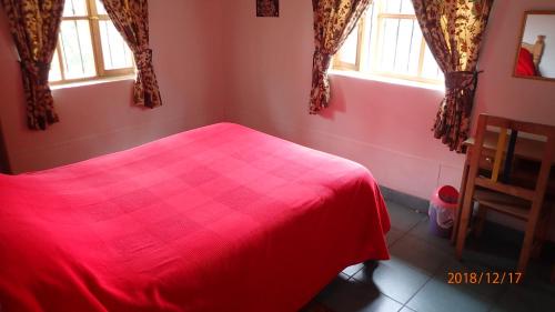 Postel nebo postele na pokoji v ubytování Hosteria Rose Cottage