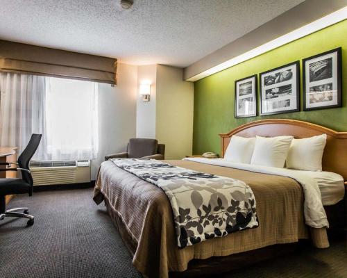 a hotel room with a bed and a window at Sleep Inn Slidell in Slidell