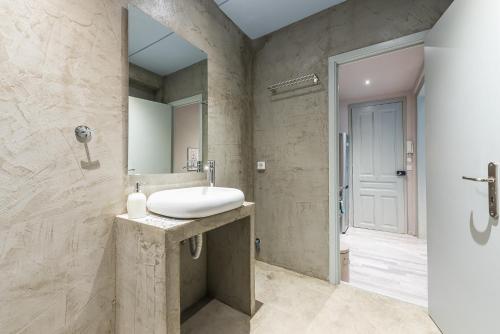 a bathroom with a sink and a mirror at Plaka Akrokeramo House #1 in Athens