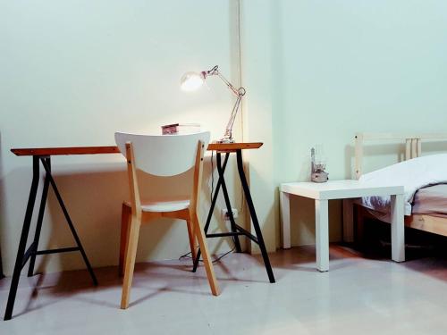 a room with a desk and a chair and a lamp at NBH.@ Prannok in Bangkok