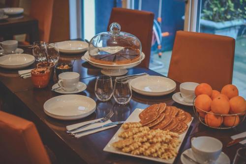 a table topped with plates and bowls of food at Hotel The Augustin in Brussels