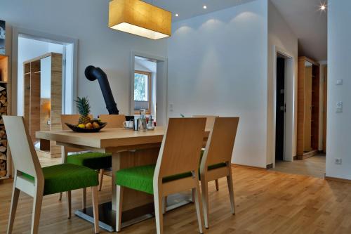 a kitchen and dining room with a wooden table and chairs at Sportappartements in Bad Mitterndorf