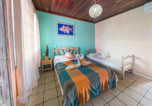 a bedroom with a bed with a child on it at Pousada Pedra D'Água Pipa in Pipa