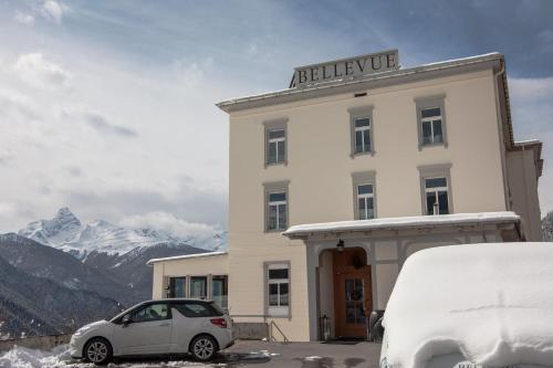 a car parked in front of a building with snow at Boutique-Hotel Garni Bellevue Davos Wiesen in Wiesen