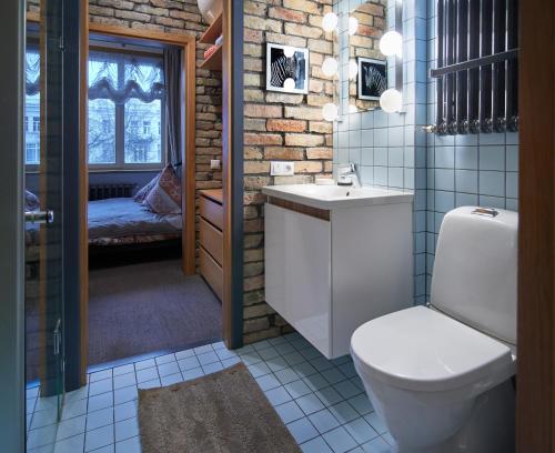 La salle de bains est pourvue de toilettes et d'un lavabo. dans l'établissement Town Hall Apartments, à Vilnius