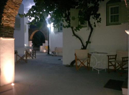a room with a tree and chairs and lights at Giannakas Studios in Platis Yialos Sifnos