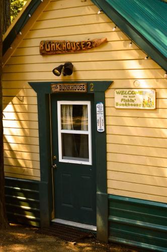 a junk house with a green door and window at Shaver Lake Village Hotel in Shaver Lake