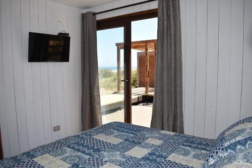 a bedroom with a bed and a view of the ocean at Morros del Pacífico in Pichilemu