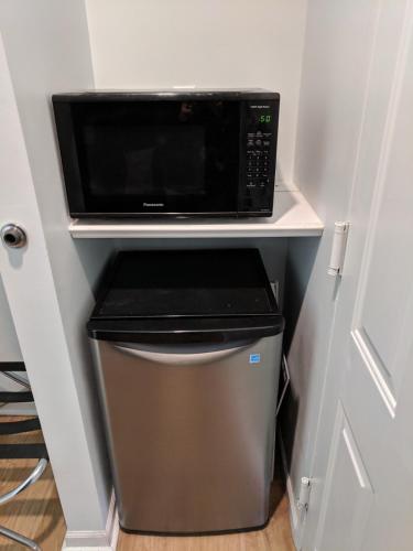 a microwave oven sitting on top of a trash can at Skylark Motel in Chicago