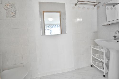 a white bathroom with a sink and a toilet at Panorama Gór w Karpaczu in Karpacz