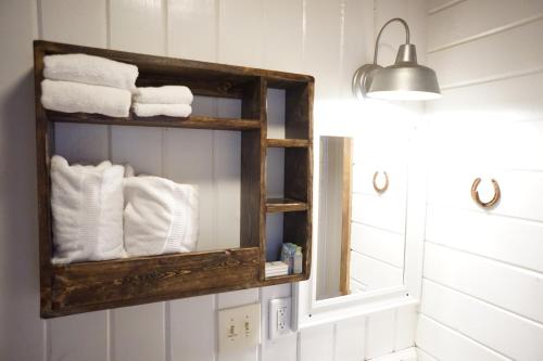 a bathroom with a mirror and white towels at Shaver Lake Village Hotel in Shaver Lake