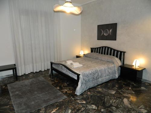 a bedroom with a bed and two tables and two lamps at B&B SAN PIO in Pellezzano