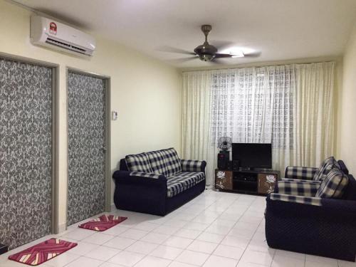 a living room with two couches and a tv at Sri Nabalu Apartment Platinum Putatan in Kota Kinabalu