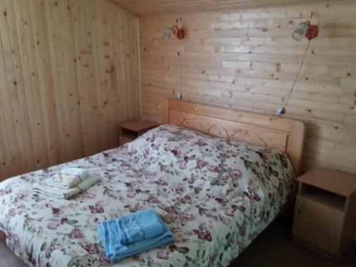 a bedroom with a bed with a floral bedspread at Смериковий in Yaremche